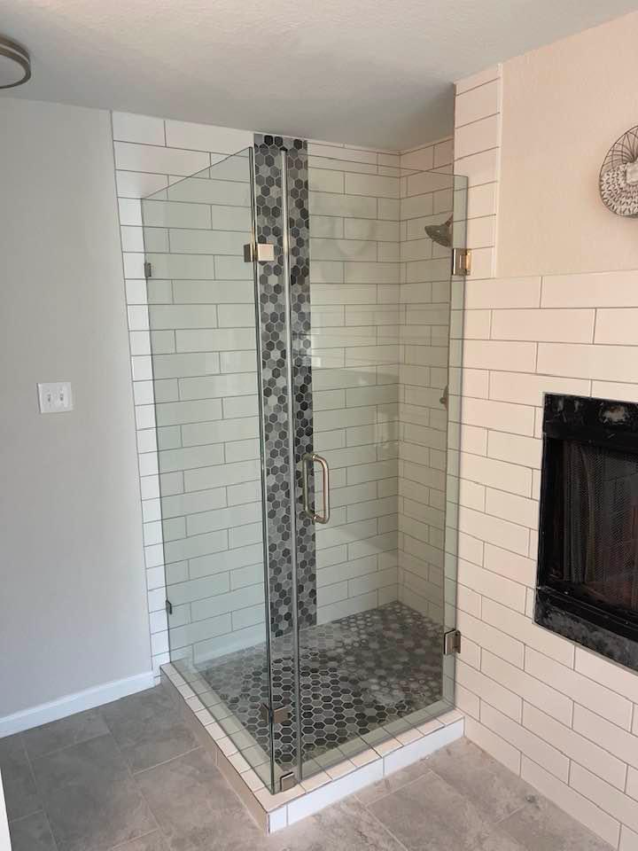White subway tile shower with glass enclosure